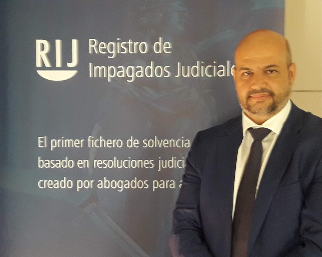 Enrique Zarza ante la imagen del Registro de Impagados Judiciales